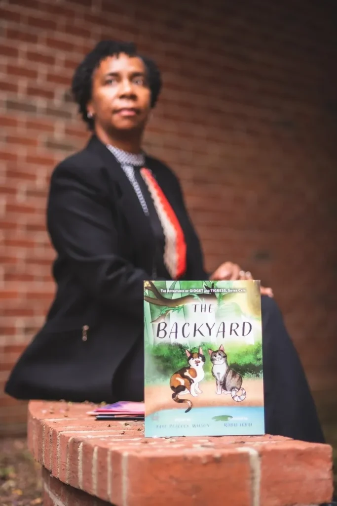 A woman in a suit and tie holding onto a book