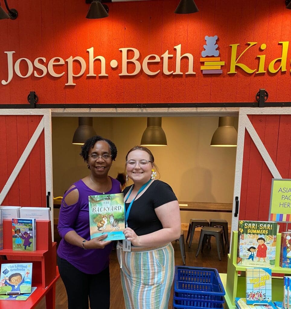 Two women standing in front of joseph beth kids.