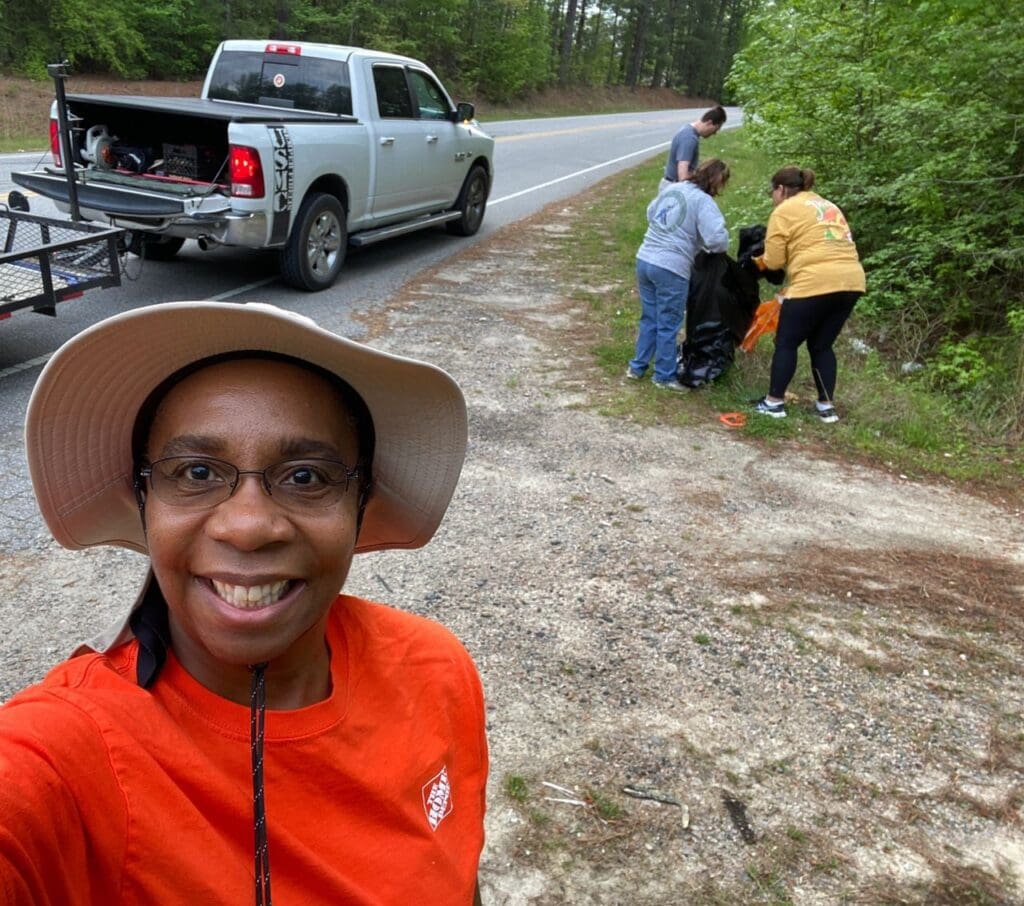 A woman taking a selfie in front of a truck.