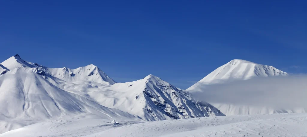 Snowy mountains under a clear blue sky.
