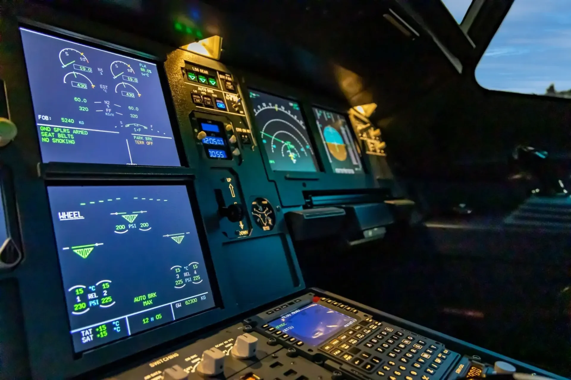 Airplane cockpit with illuminated control panels.