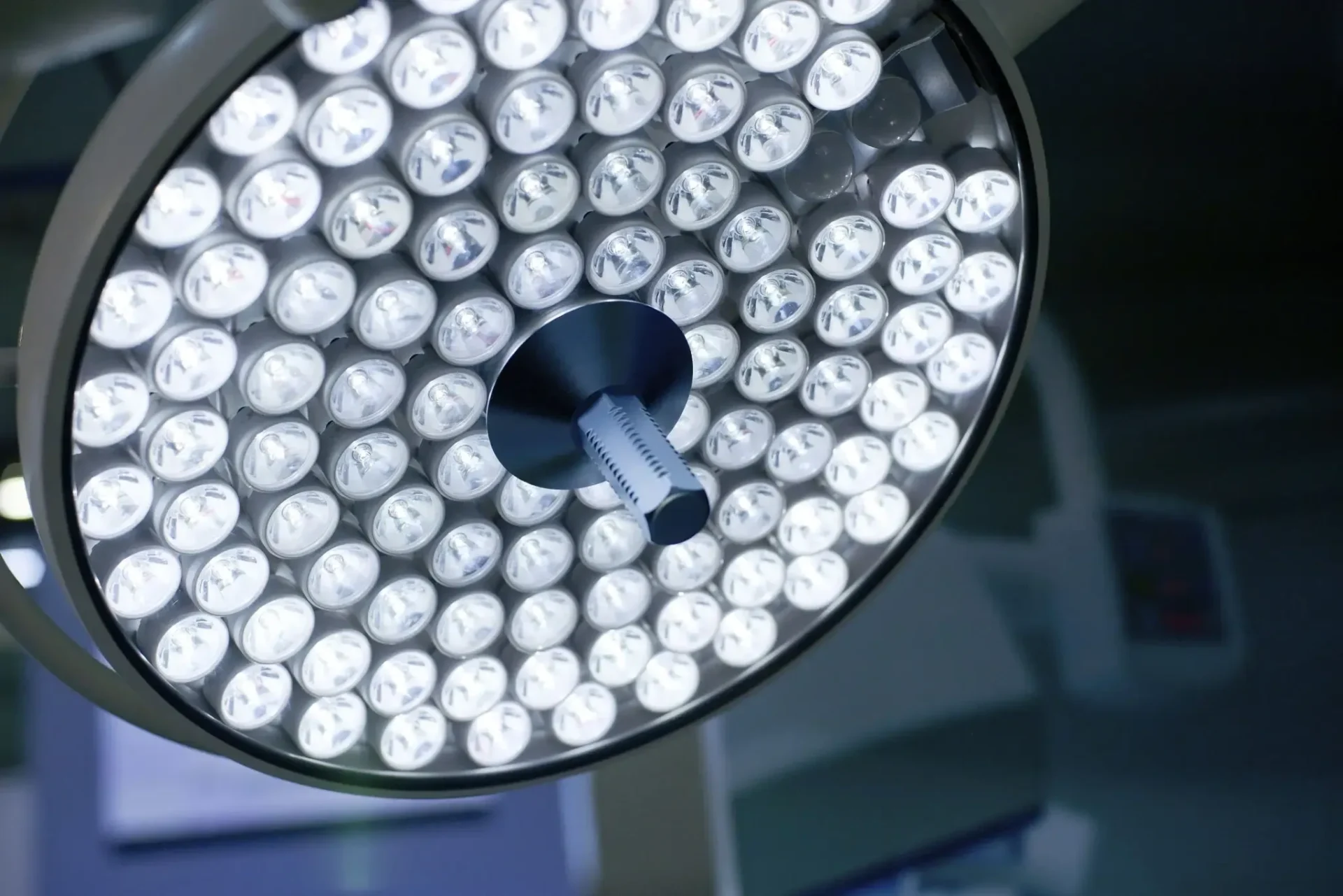 Surgical operating room light fixture illuminated.