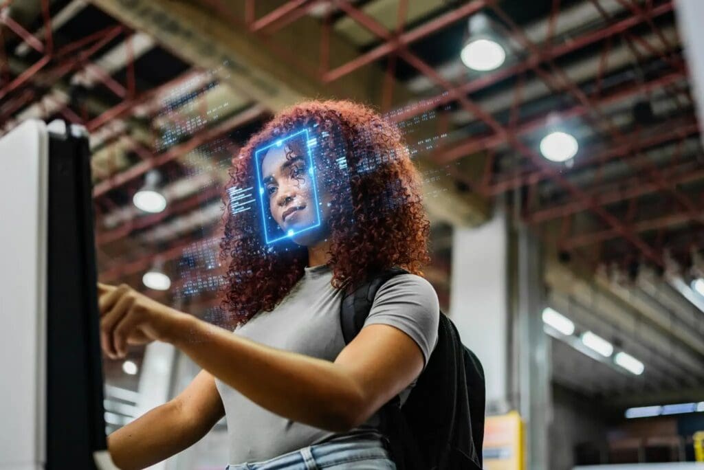Woman using facial recognition technology in airport.
