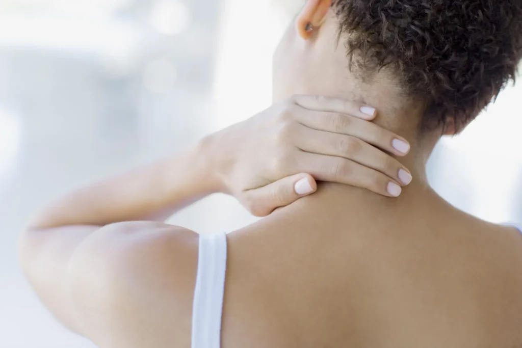 Person holding neck in pain