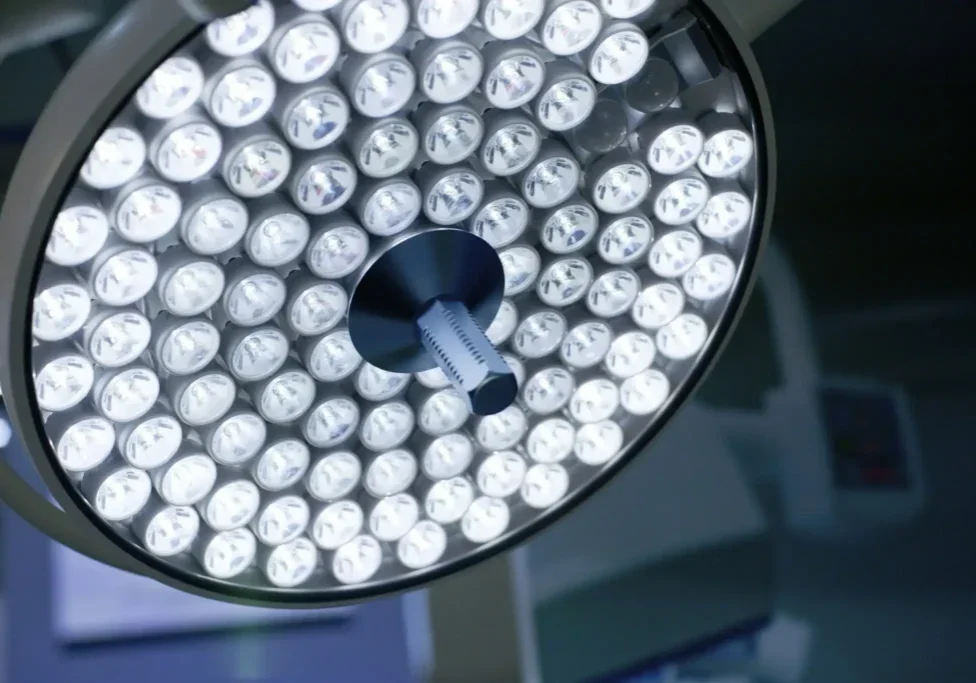 Surgical operating room light fixture illuminated.