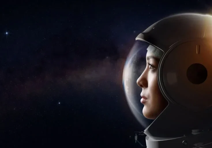 Astronaut gazing into space with helmet.