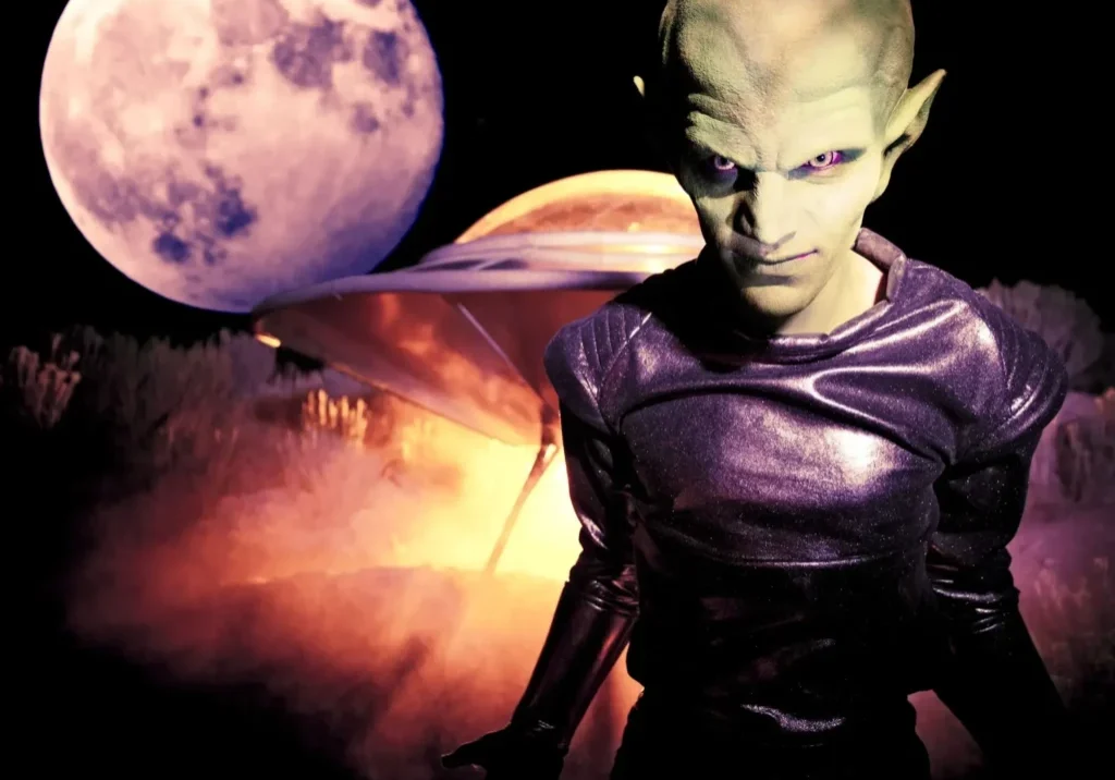 Alien with UFO and moonlit background.