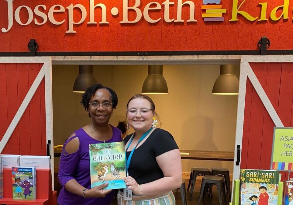 Two women standing in front of joseph beth kids.