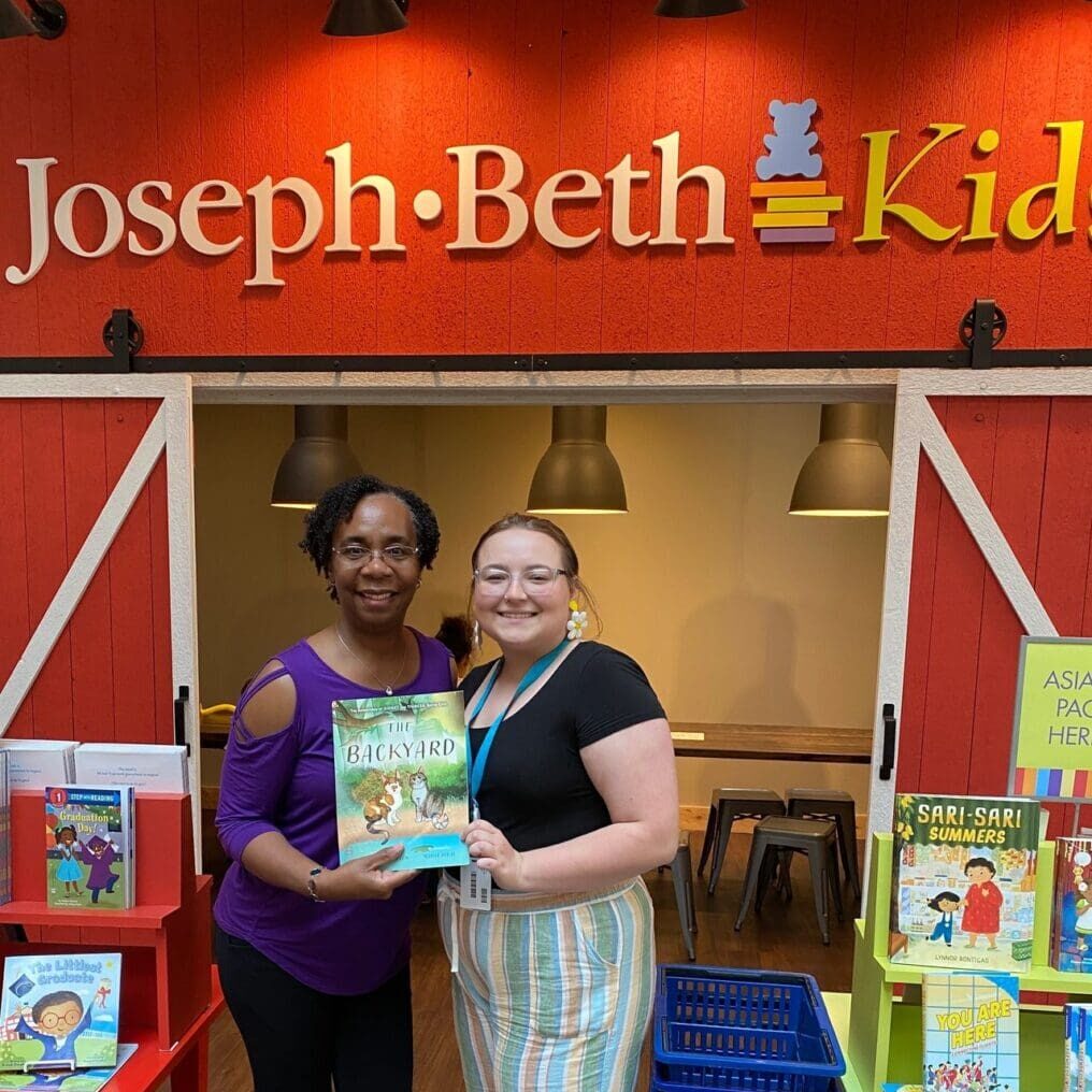 Two women standing in front of joseph beth kids.