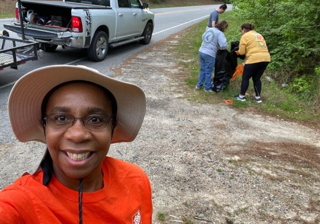 A woman taking a selfie in front of a truck.