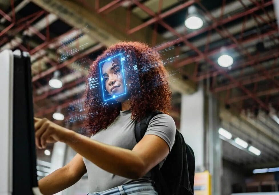 Woman using facial recognition technology in airport.